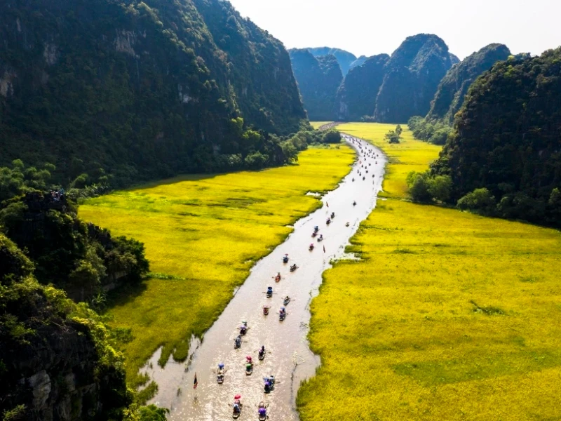 Tam Coc Bich Dong Travel Guide 2025: Top Things to Do, How to Get There & Insider Tips Tam Coc Bich Dong landscape with limestone mountains, rice paddies, Ngo Dong River, and Bich Dong Pagoda in Ninh Binh, Vietnam
