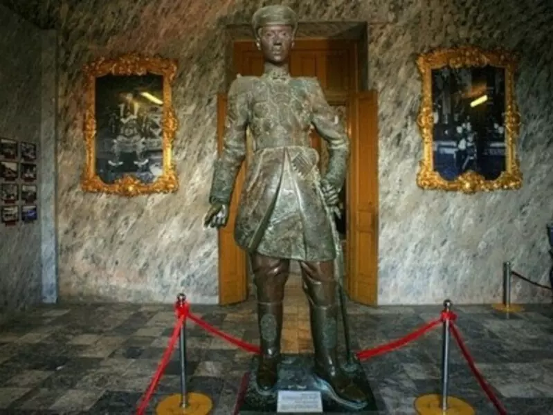 Khai Dinh Tomb: Location, Ticket Price, Architecture & Travel Tips Bronze statue of King Khai Dinh seated on the throne, created by French artists, with a golden finish at Khai Dinh Tomb.