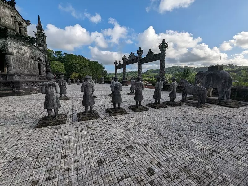 Khai Dinh Tomb: Location, Ticket Price, Architecture & Travel Tips Nghi Mon area and Bai Dinh Courtyard at Khai Dinh Tomb, with detailed life-sized statues of royal figures.