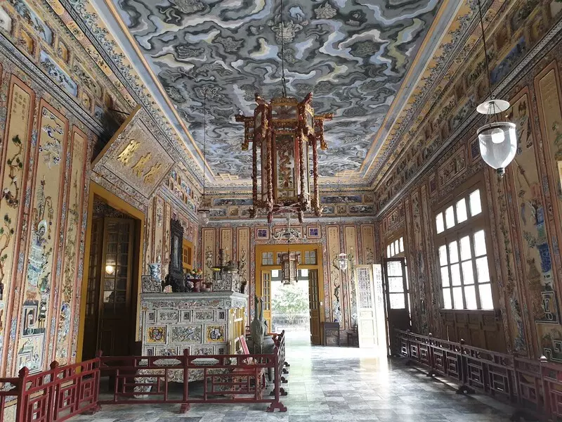 Khai Dinh Tomb: Location, Ticket Price, Architecture & Travel Tips Thiên Định Hall at Khai Dinh Tomb, with intricate ceramic and glass mosaic decorations and the king's statue.