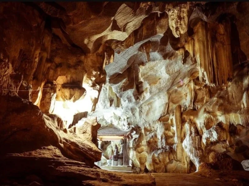 Tam Coc Bich Dong Travel Guide 2025: Top Things to Do, How to Get There & Insider Tips Scenic view of Thiên Hương Cave and the Linh Tu Temple with lush mountains in Ninh Binh.