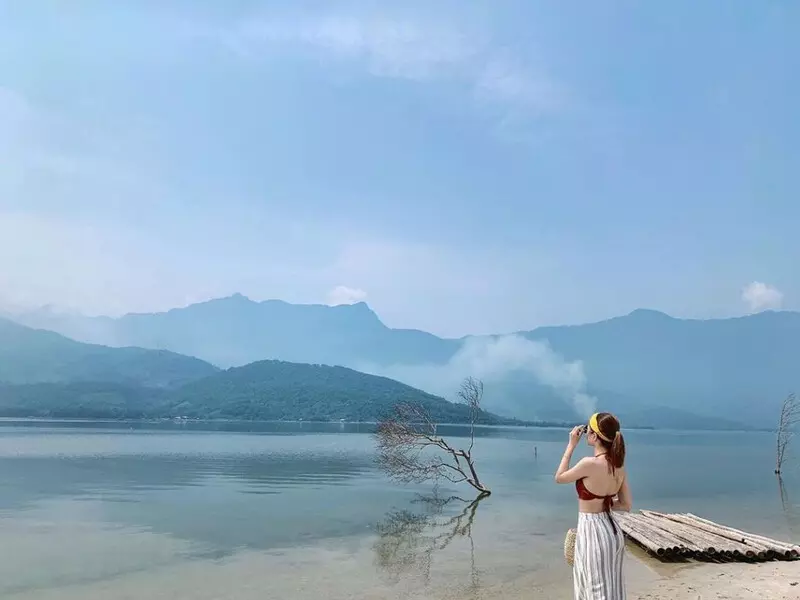 When Is the Best Time to Visit Hue? Discover the Most Beautiful Season in the Ancient Capital Tourists swimming and relaxing at Lang Co Beach during Hue’s summer season.