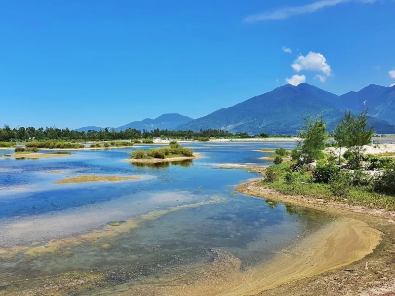 How to Explore Lap An Lagoon in Hue: Full Travel Tips & Guide Peaceful natural landscape of Lap An Lagoon with still water, lush greenery, and mountain backdrop